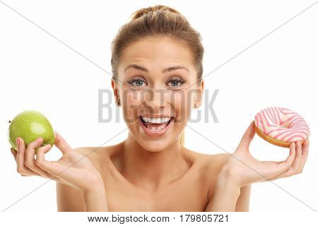 Adult woman posing with donuts over white background