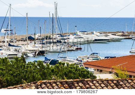 yacht boat and Fishing boats in a harbor on sardegna island in italy