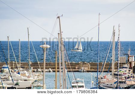 yacht boat and Fishing boats in a harbor on sardegna island in italy
