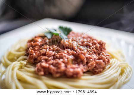hot spaghetti with red meat sauce on big white plate. Health food concept