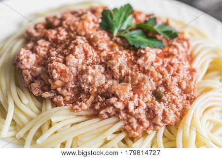 hot spaghetti with red meat sauce on big white plate close up. Health food concept