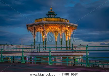 Brighton bandstand at sunset against blue sky