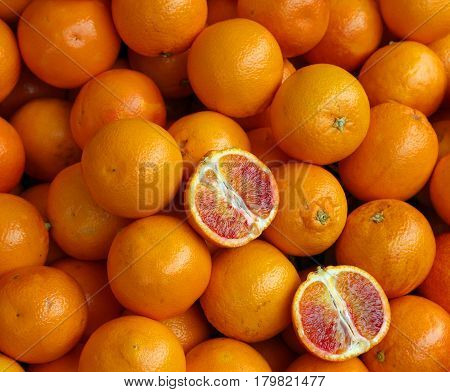 Ripe Oranges And An Orange Cut In The Stall Of Greengrocer