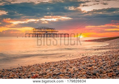 Dramatic sky over Brighton West Pier at sunset