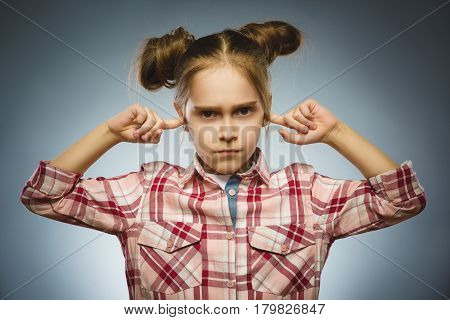 Closeup portrait of worried girl covering her ears, observing. Hear nothing. Human emotions, facial expressions.