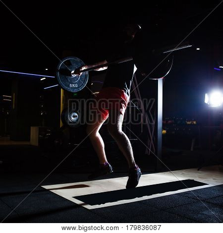 Gym and fitness concept - athlete and barbell