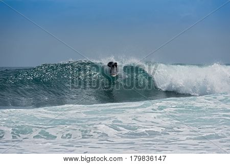 PUERT VIEJO, COSTA RICA-MARCH 19, 2017: Surfer on the beach near Puerto Viejo, Costa Rica
