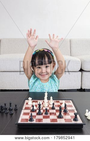 Happy Asian Chinese Little Girl Playing Chess Chess At Home