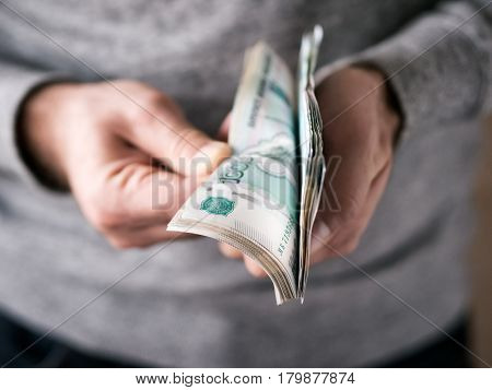 Hands counting russian rubles. Selective focus. Shallow DOF