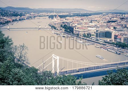 The stunning view overlooking Budapest in the daytime from Gellert Hill looking along the River Danube in a vintage toned image.