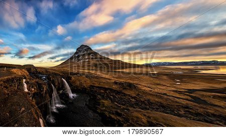 Spring Sunrise Over The Famous Kirkjufellsfoss Waterfall With Kirkjufell Mountain In The Background