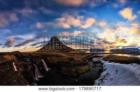 Spring Sunrise Over The Famous Kirkjufellsfoss Waterfall With Kirkjufell Mountain In The Background