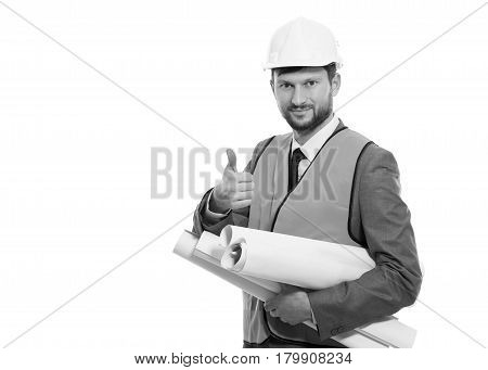 Thumbs up for development. Cheerful mature businessman engineer smiling showing thumbs up posing with blueprints in his hands wearing protective helmet and orange safety vest