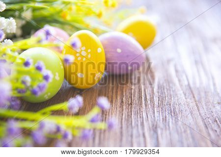 Easter Eggs With Flowers On Rustic Wooden Background