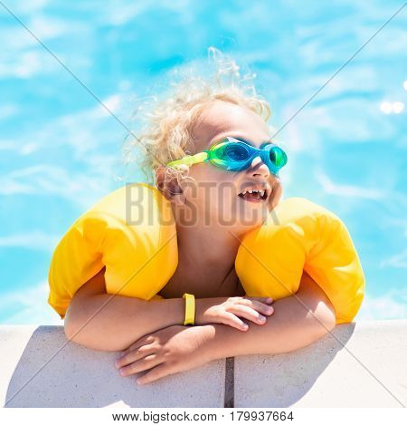 Little Baby Boy Playing In Swimming Pool