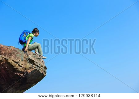 successful woman hiker hiking on mountain top
