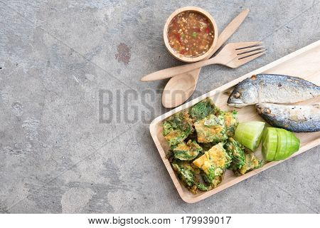 Thai local popular food as spicy shrimp paste dip (Nam Prik Kapi in Thai) served with fried mackerels sliced cucumber and fried acacia pennata omelet