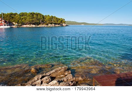 Transparent Deep Blue Sea Water And Rocky Coast