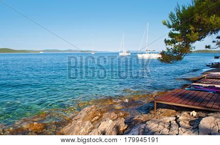 Transparent Deep Blue Sea Water And Rocky Coast