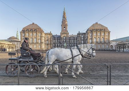 COPENHAGEN DENMARK - DECEMBER 24 2016: Horses and cart with rider at Christianborg palace courtyard in Copenhagen Denmark