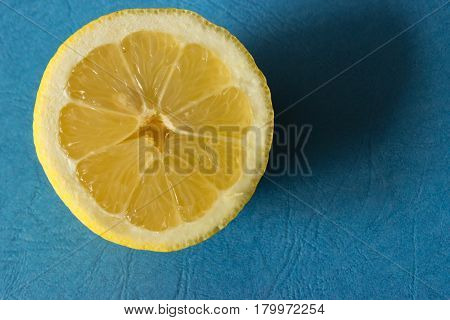 In the background is illuminated lemon cut in half.