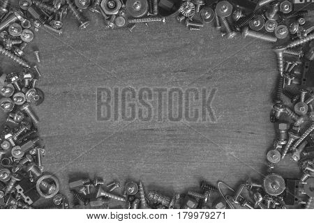 frame made of screws, bolts on a desk ready for repair something in black and white