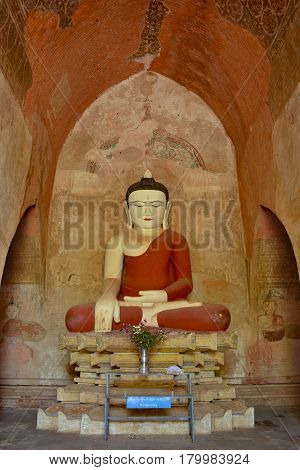 Very Old Buddha Sculpture Inside Pagoda In Bagan, Myanmar. Ancient Frescos On The Walls Of Pagoda.