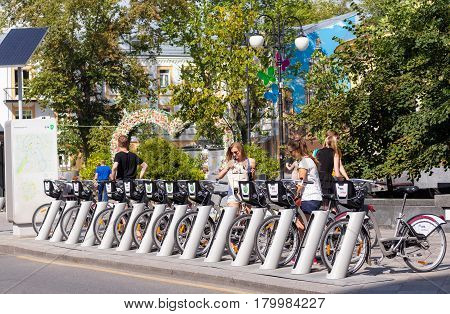 MOSCOW - AUGUST 7 2016: Young people at bicycle rental station on Pyatnitskaya street. The project of urban bike rental started in 2013.
