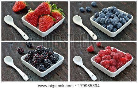Mix of strawberries, blueberries, blackberries and raspberries fruit on wood table. Forest fruit in white idaeus with spoons. Delicious fresh berries.