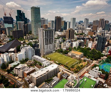 TOKYO JAPAN - JUNE 10: View at modern skyscrapers in Roppongi district in Minato Tokyo at June 10 2015. This district is well known as the city's most popular nightlife district.