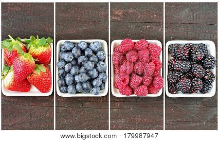 Mix of strawberries, blueberries, blackberries and raspberries fruit on wood table. Forest fruit in white idaeus. Delicious fresh berries.
