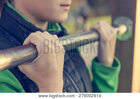 Detail Of Female Hands Holding A Pullup Bar At Outdoor Fitness.