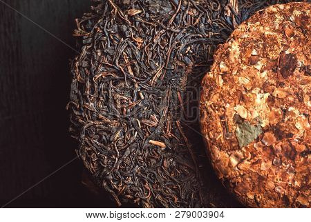Puer Tea Background. Pu-erh Cakes Dark Color And Floral Leaf Tea. Traditional Chinese Beverage And P