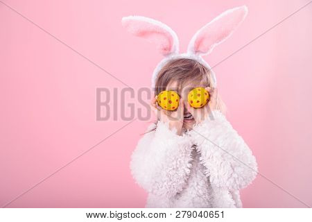 Portrait Of A Little Girl With Bunny Ears And Easter Eggs