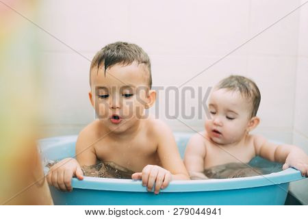 Children, Brother And Sister In The Bathroom Swimming, Playing Splashing