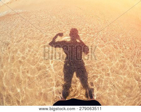 Man Pumped Up Muscles Makes Selfie Silhouette Shadows From Sun On Golden Sand And Sea. Concept Prepa