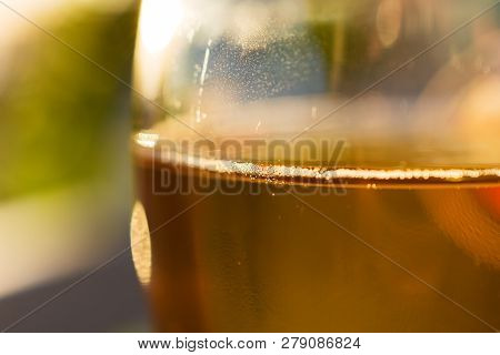 Glass Of Greek Retsina Wine With Bubbles At Sunset
