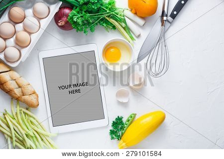 Cooking Concept, Tablet Computer And Breakfast Ingredient On White Bacjground