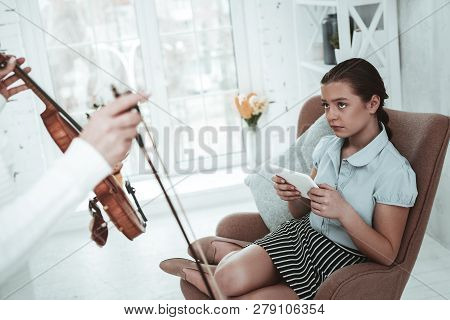 Nice Cheerless Girl Playing On Her Smartphone