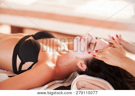 Spa Mask. Beautiful Woman Get Spa Mask On The Sunny Beach In Spa Salon Outdoor. High Quality. Scin C