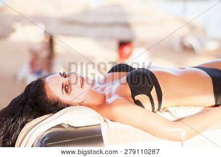 Spa Mask. Beautiful Woman Get Spa Mask On The Sunny Beach In Spa Salon Outdoor. High Quality. Scin C