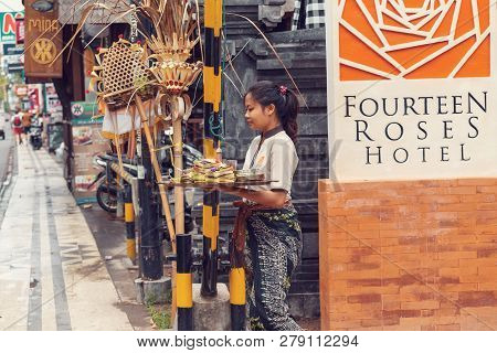 Bali, Indonesia - August 03 2015: A Woman Is Offering Sacrifice In A Small Home Temple In Kuta City,