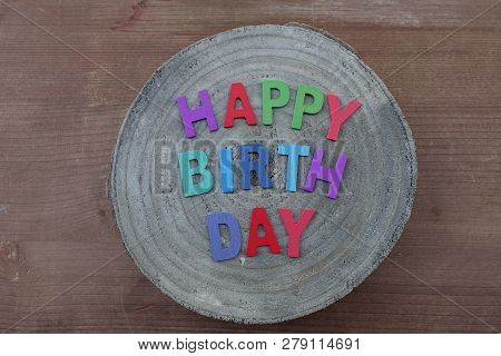 Happy Birthday Text With Colored Wooden Letters On A Mango Wooden Round Board