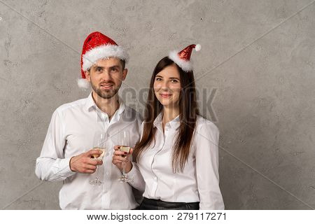 Young Business People Holging Glasses Of Champagne And Looking At Camera