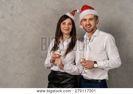Young Business People Holging Glasses Of Champagne And Looking At Camera