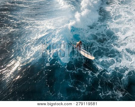 OAHU / USA - 17 NOVEMBER 2018: Surfer rides the ocean tropical wave on the longboard. Aerial view of Makaha surf spot, west coast of Oahu, Hawaii