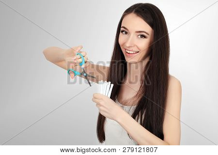 Stop Smoking Concept. Young Woman Cut Cigarettes With Scissors Happy Smiling. Focus On Hand, Scissor