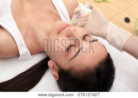 Woman Gets Injection In Her Face. Beauty Woman Giving Injections. Young Woman Gets Beauty Facial Inj