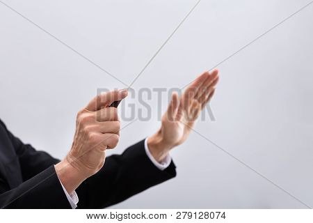 Person Directing With Conductors Baton