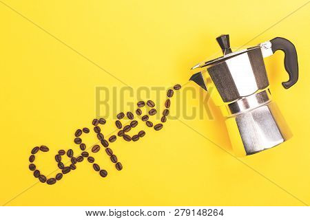 Coffee Beans Pouring From Coffee Maker Into Coffee Word On Yellow Background. Love Coffee Concept. F